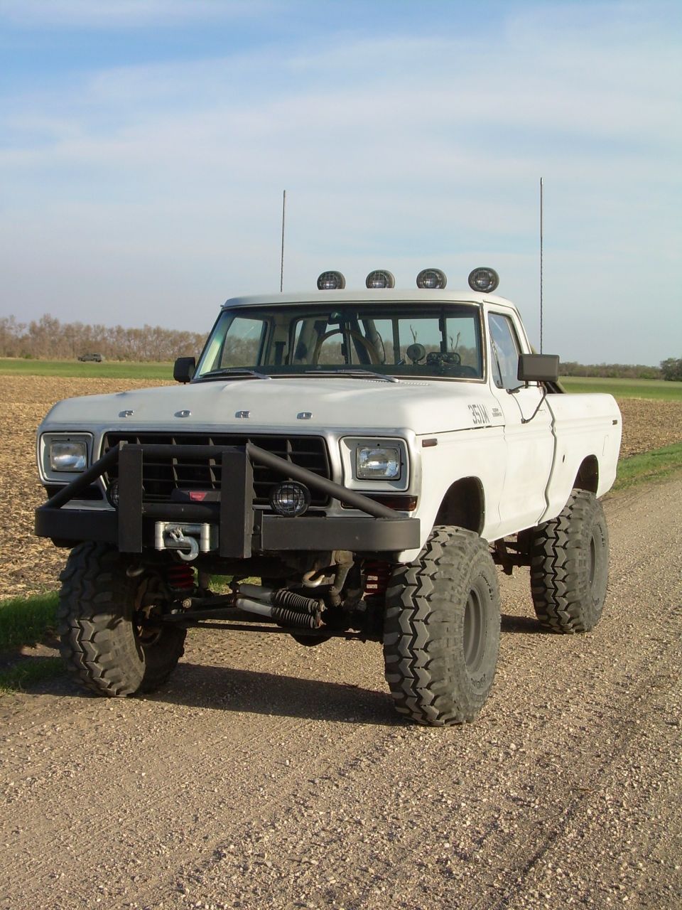 1978 Ford F-150 pickup truck, lifted with large off-road tires and custom front bumper with winch