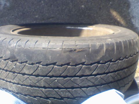 1997 Ford Probe - A close-up view of a worn tire shows significant damage to the sidewall.