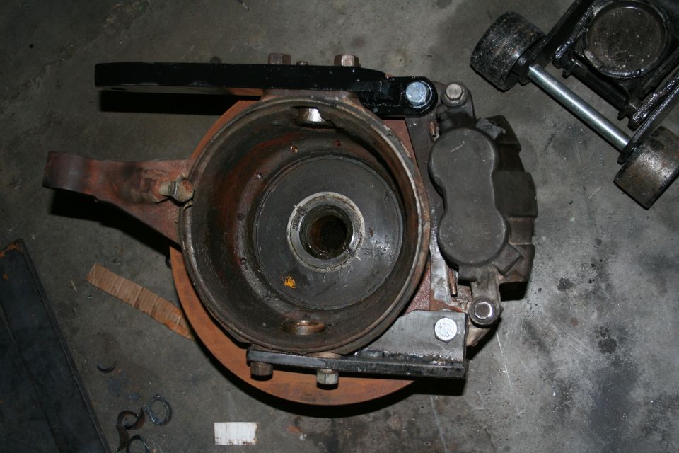 Front passenger knuckle with high-steer arm, rotor & caliper. To get the knuckle of the axle you have to pull the axle shafts, which means complete disassembly of the knuckles.

Notice how the caliper is slightly rotated toward the top of the knuckle. I did this so that I will be less likely to scrape them on rocks/obstacles. The bolts on the caliper are 16mm coarse thread, grade 8.8 (equivalent to a grade 5) and are temporary.