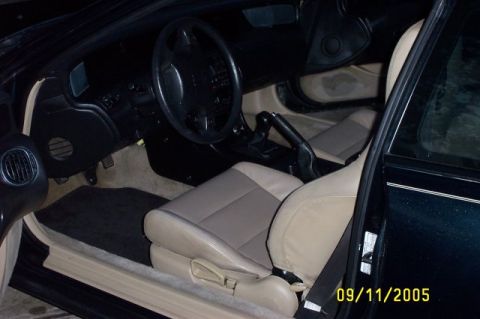2001 Ford Crown Victoria - The interior of a car is shown, tan seats and a black dashboard. A watermark indicates the photo was taken on 09/11/2005.