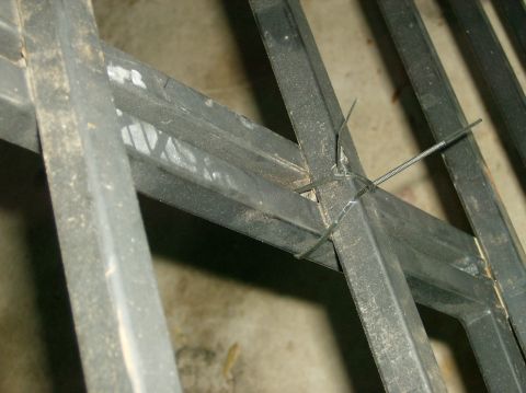2004 Jeep Wrangler - Metal rack components are held together with zip ties, with a Supermotors.net watermark.