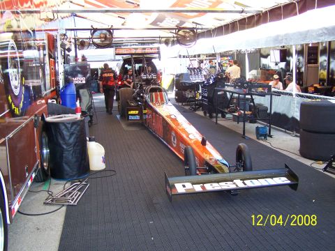 1973 Ford Mustang - A dragster with Prestone sponsorship is parked in a pit area, with a date stamp indicating it was photographed on December 4, 2008.