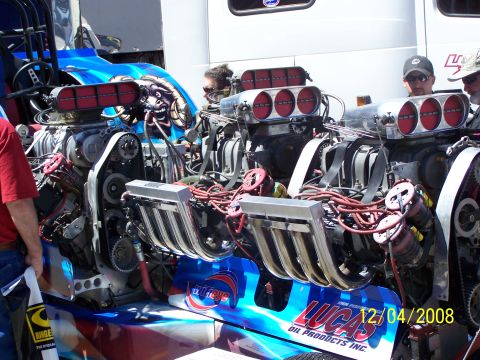 1973 Ford Mustang - Close-up of a powerful dual supercharged engine, likely for drag racing, with visible branding.