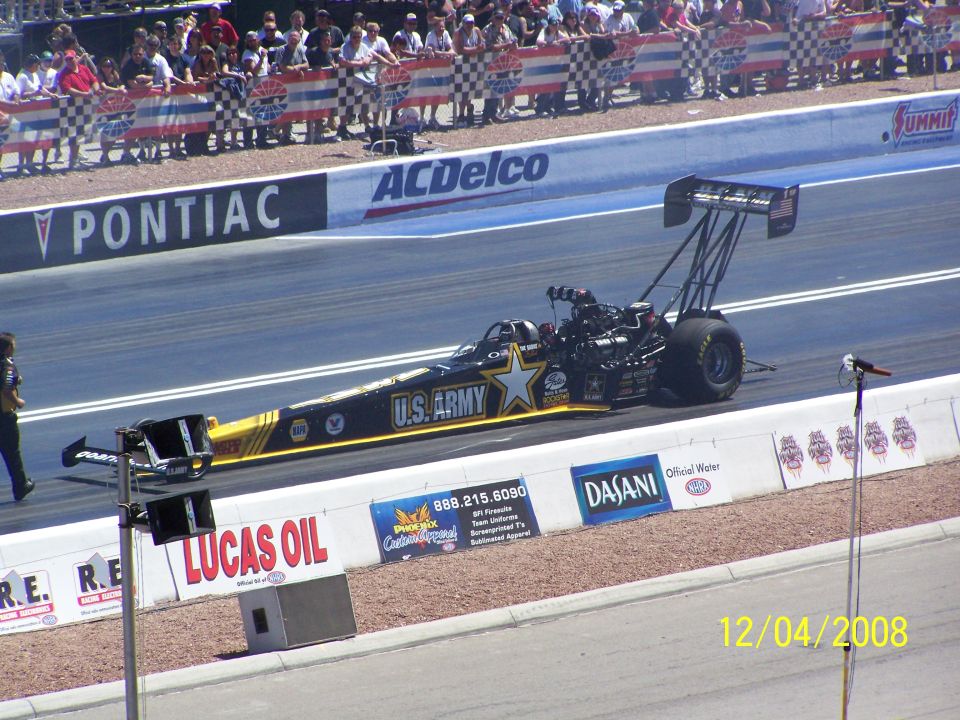 U.S. Army dragster on track with crowd in background