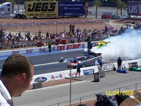 1973 Ford Mustang - Drag racing cars generate smoke on the track, with a large JEG'S billboard visible in the background.