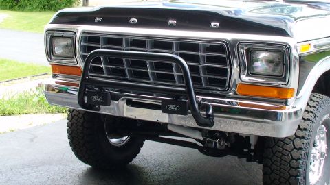 1979 Ford Bronco - Close-up of the front grille and bumper of a 1979 Ford Bronco, a black bull bar and chrome accents.