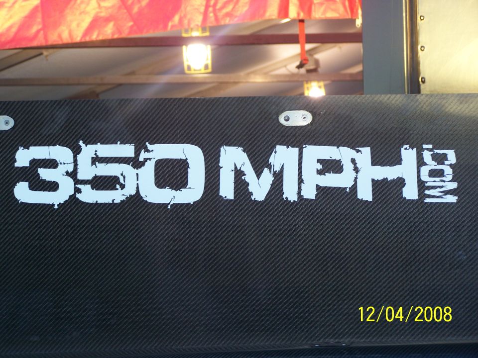Black part with carbon fiber texture and white text '350 MPH.COM'. Date 12/04/2008 and Supermotors.net logo visible