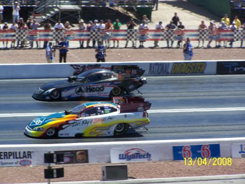 1973 Ford Mustang - Two drag cars are racing down the track at a national event.