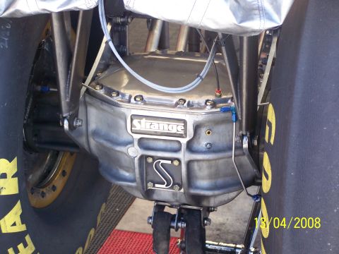 1973 Ford Mustang - Close-up of a rear differential assembly, likely from a drag racing vehicle, with visible branding and plumbing.