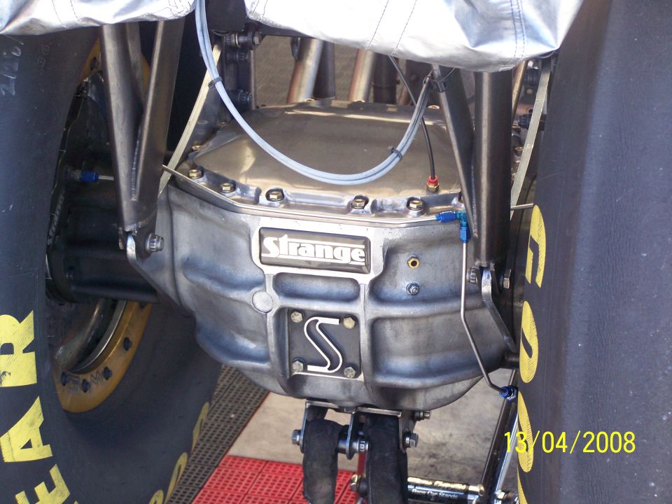 Rear differential with 'Strange' branding and an 'S' logo, between large tires