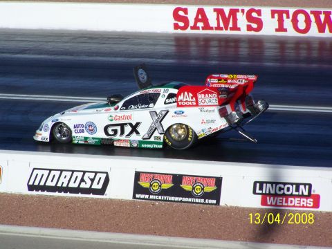 1973 Ford Mustang - A funny car drag racer with prominent GTX sponsorship speeds down the track.
