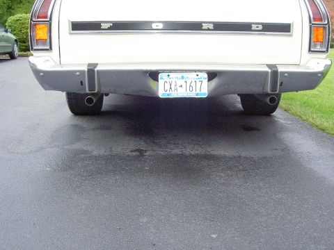 1972 Ford Ranchero - The rear bumper and taillights of a white Ford pickup truck are visible, along with a license plate.