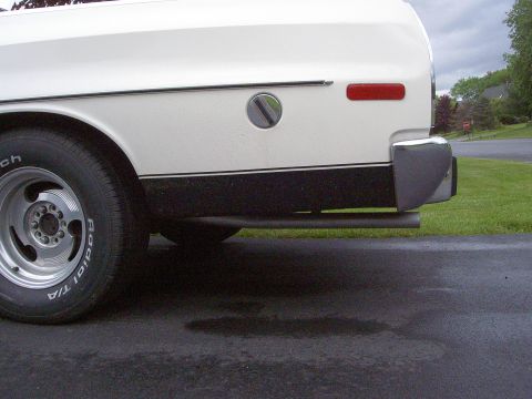 1972 Ford Ranchero - The rear of a white 1972 Ford Ranchero shows its chrome bumper and exhaust pipe.
