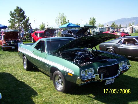 1973 Ford Mustang - A green 1972 Ford Ranchero is displayed at an outdoor car show with its hood open.