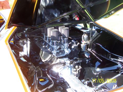 1973 Ford Mustang - Engine bay with V8 engine and carburetors. Text "Pantera" is visible on the engine.