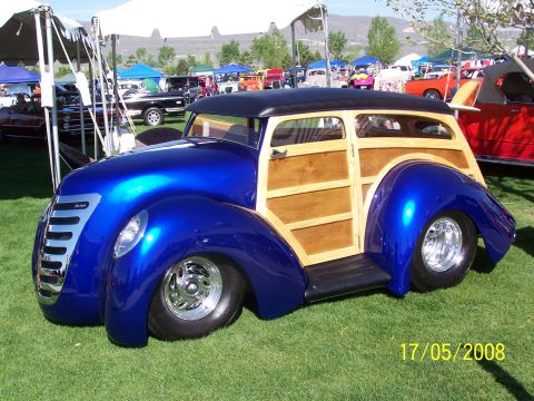 1973 Ford Mustang - Custom hot rod woody wagon with a blue metallic finish and wood paneling at a car show.