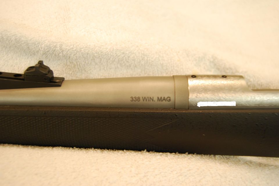 Rifle receiver with caliber marking and engraved bolt shroud.