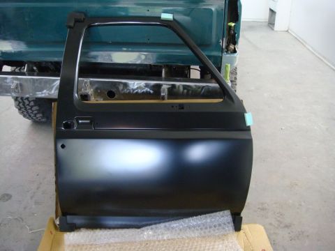 1996 Ford Bronco - Photograph of a freshly painted Ford Bronco door shell during restoration, not a technical document.