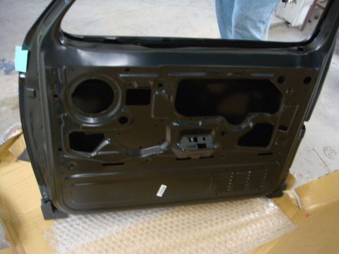 1996 Ford Bronco - Photograph of the inner side of a painted vehicle door shell during restoration, not a technical document.