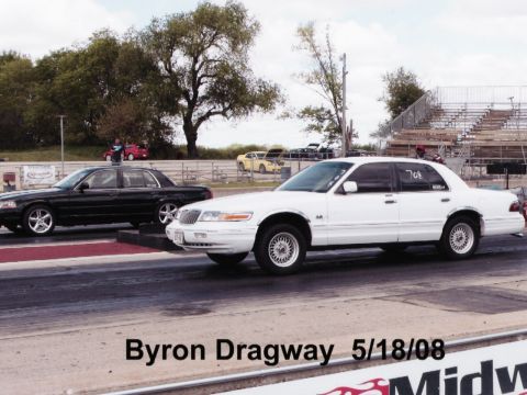 1997 Mercury Grand Marquis - Two sedans are lined up on a drag strip at Byron Dragway on May 18, 2008. A white Mercury Grand Marquis is in the foreground, with a black…