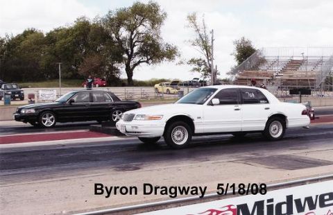 1997 Mercury Grand Marquis - A white Mercury Grand Marquis is parked on a drag strip next to a black Mercury Grand Marquis. The text "Byron Dragway 5/18/08" is visible…
