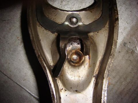 1975 Chevrolet Corvette - A detailed view of a worn clutch fork mechanism, showing metal components and grease buildup.