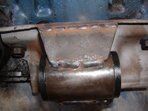 1991 Ford Bronco - Close-up view of a custom welded metal bracket mounted to an engine block.