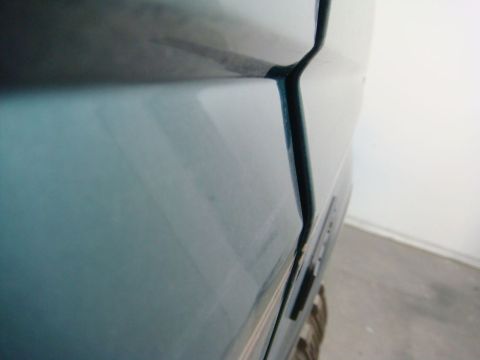 1996 Ford Bronco - Close-up photograph of a painted vehicle body panel gap, not a technical document.