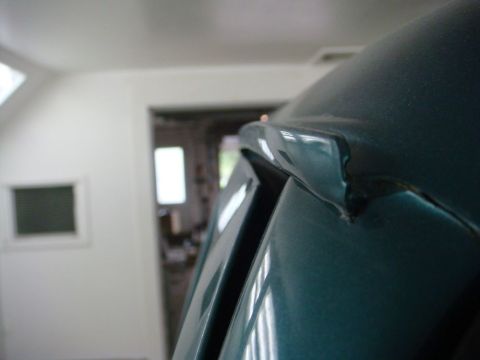 1996 Ford Bronco - Close-up photograph of a painted vehicle pillar and roofline, not a technical document.