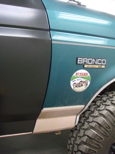 1996 Ford Bronco - Close-up of the side panel of a 1996 Ford Bronco, the Bronco Eddie Bauer badging and a sticker of a lifted 4x4.