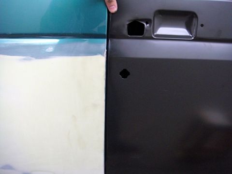 1996 Ford Bronco - Two vehicle door panels are shown, one prepared for paint and the other black, black, ready for assembly.