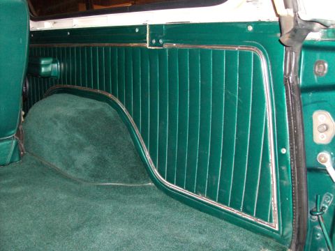 1978 Ford Bronco - The interior of the vehicle features green carpet and matching ribbed door panels.