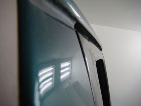 1996 Ford Bronco - Close-up of a car's door trim, showing the chrome and rubber seal detail.