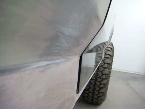 1996 Ford Bronco - Close-up of a vehicle's rear fender flare and off-road tire, showing bodywork details.