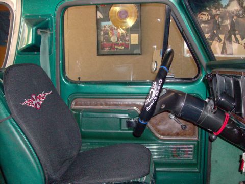1978 Ford Bronco - Interior view of a 1978 Ford Bronco, a custom seat cover and a gold record award displayed on the wall.