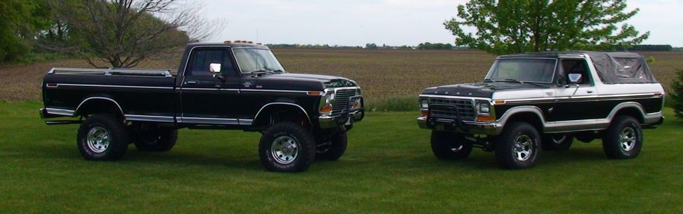 Black and white Ford Bronco with a soft top, viewed from the front-right