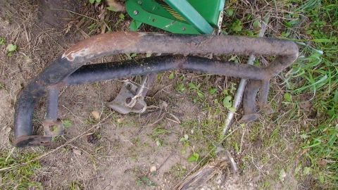 1979 Ford Bronco - These old metal bars are covered in rust and dirt, suggesting they are a salvaged part.