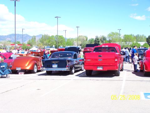 1972 Ford Ranchero - Several classic and modern vehicles are parked at an outdoor car show on a sunny day.