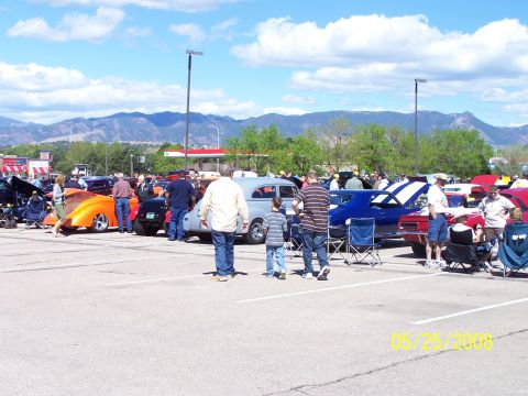 1972 Ford Ranchero - A sunny day at a car show with many vehicles on display and people walking around.