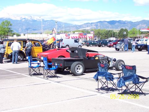 1972 Ford Ranchero - A custom hot rod pickup truck is displayed at a car show with mountains in the background.