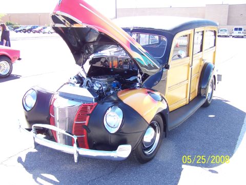 1972 Ford Ranchero - A custom 1940 Ford Woody Wagon is displayed with its hood open, revealing the engine and flame graphics on the front fenders.