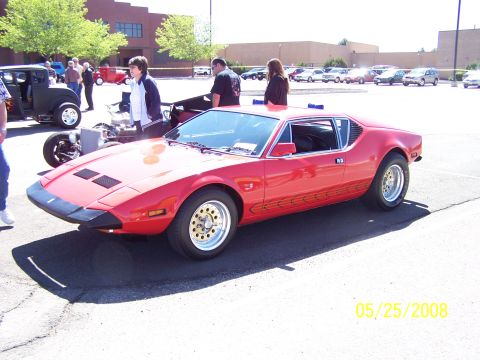 1972 Ford Ranchero - Red sports car with distinctive body lines and wheels at a car show.