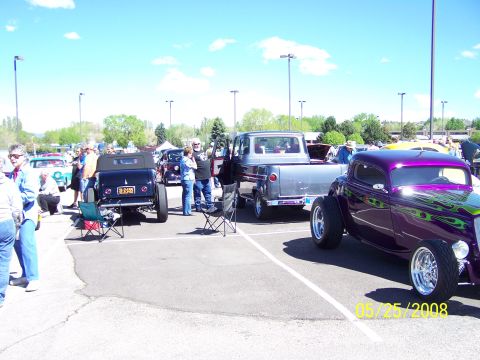 1972 Ford Ranchero - A purple hot rod with custom flame paint is displayed at an outdoor car show on a sunny day.