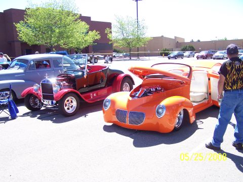 1972 Ford Ranchero - An orange hot rod is displayed with its hood and doors open at an outdoor car show.