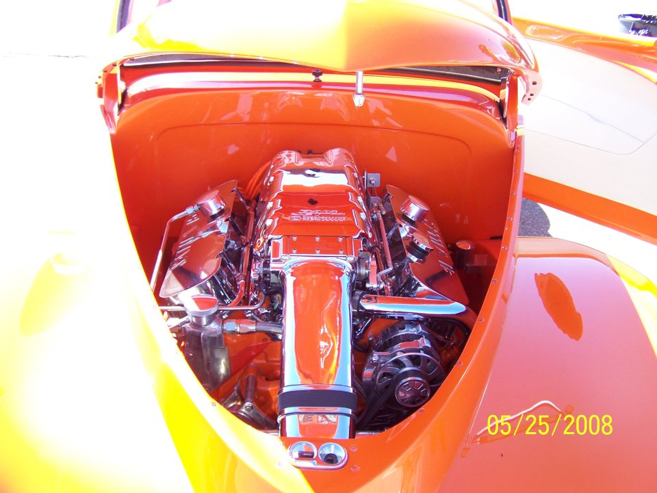 Chrome engine in orange engine bay of a custom hot rod. Date 05/25/2008 visible