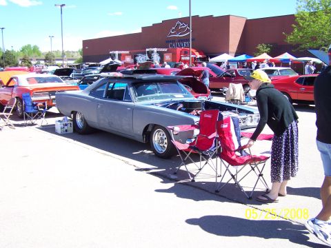 1972 Ford Ranchero - A gray 1969 Dodge Charger is displayed at a car show with its hood open.