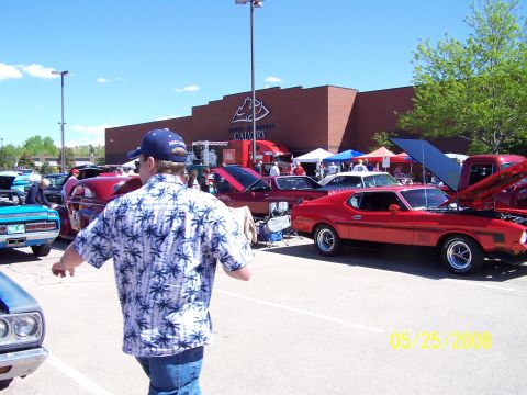 1972 Ford Ranchero - A red 1971 Ford Mustang Mach 1 is displayed at a car show with its hood up.