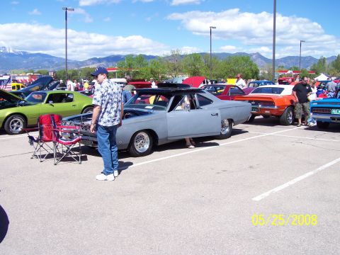 1972 Ford Ranchero - Several cars are on display at an outdoor car show under a partly cloudy sky.
