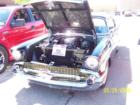 1972 Ford Ranchero - 1957 Chevrolet Bel Air at a car show, hood up, next to a red Ford pickup. Date stamp visible.