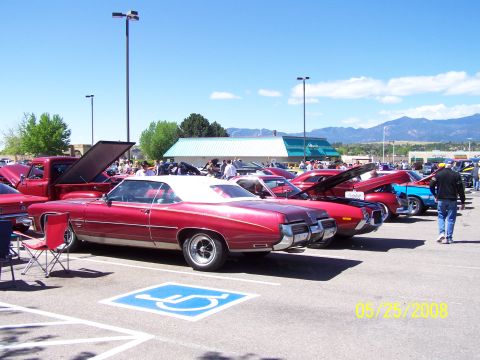 1972 Ford Ranchero - A red convertible with a white top is parked at a car show on 05/25/2008, with other vehicles and spectators in the background.